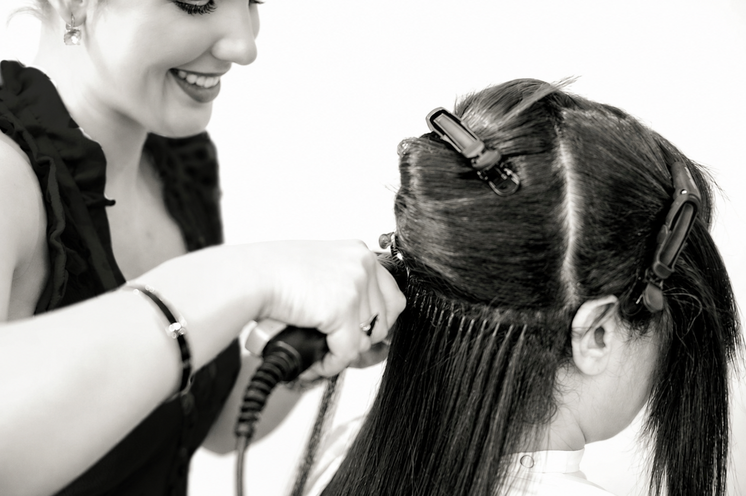 Lauren smiling while installing a visible row of K tip extensions